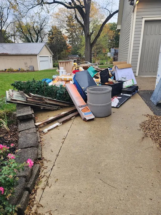 Dumpster being loaded with debris for 12 Yard Dumpster Rental in Edgemoor